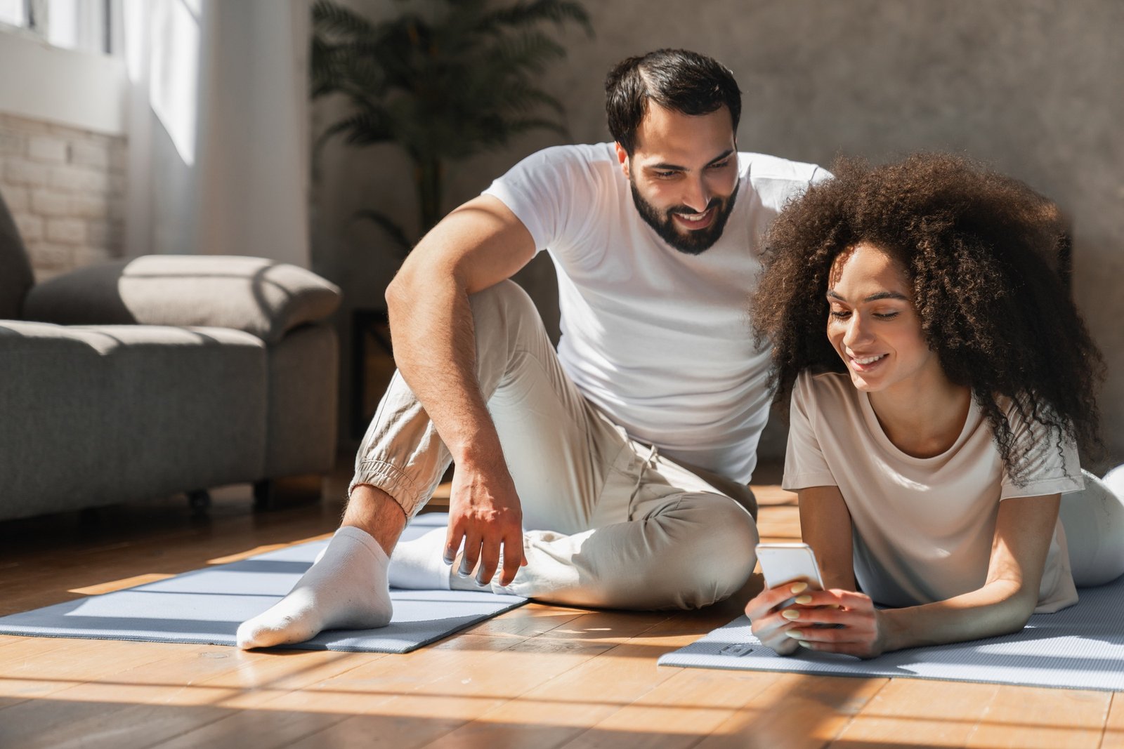 Healthy couple doing workout at home.
